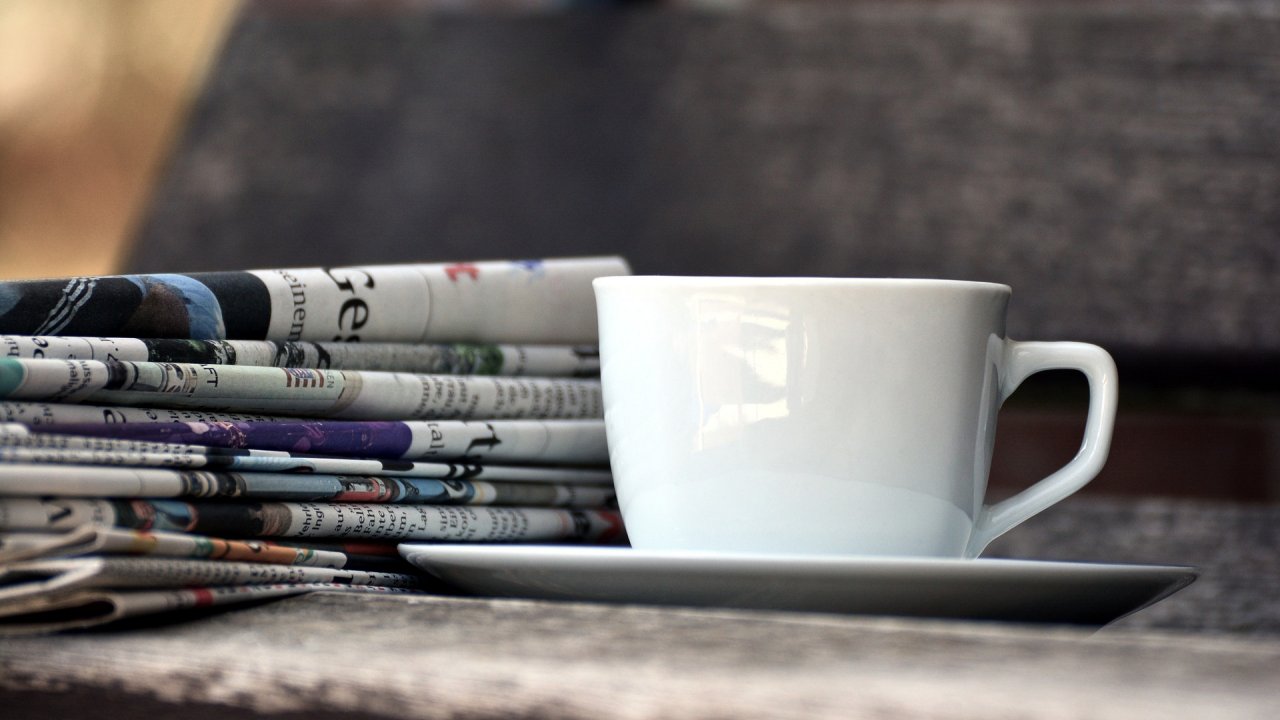 Magazines and a coffee cup