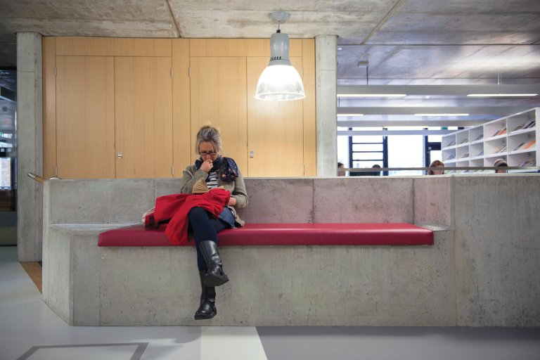 Person sitting on bench reading