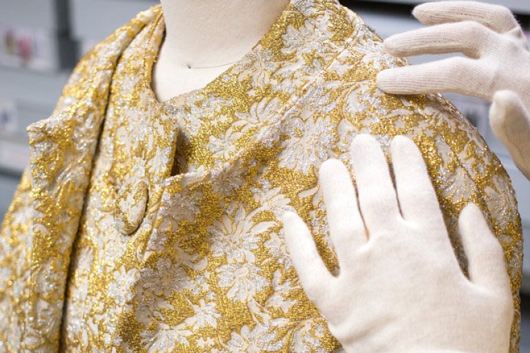 Detail of a gold brocade coat on a manequin