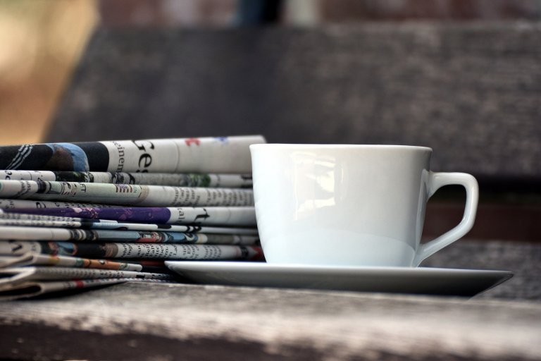 Magazines and a coffee cup