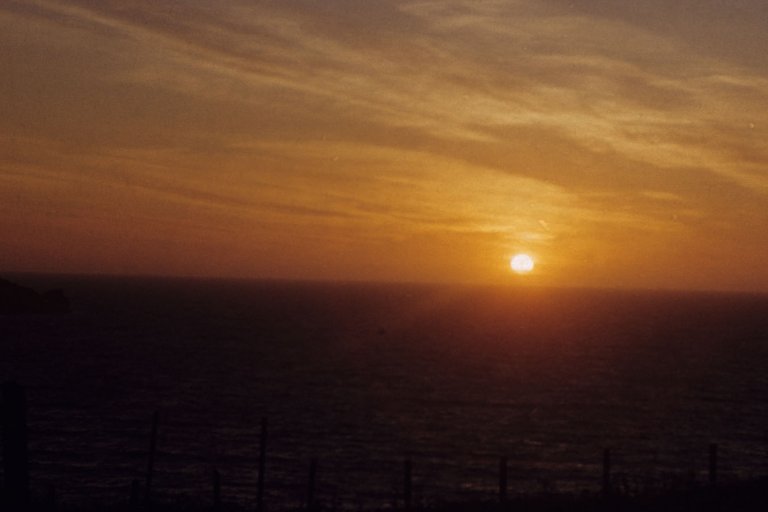 Colour image from Charles Woolf Slide Collection showing sunset over the sea at Newquay in 1953