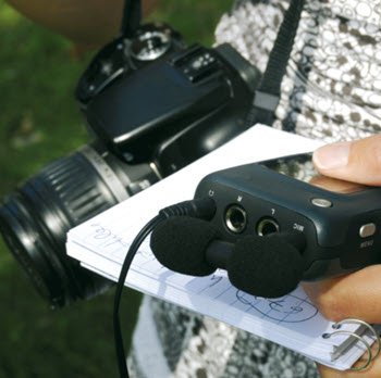 journalist holding camera and notepad