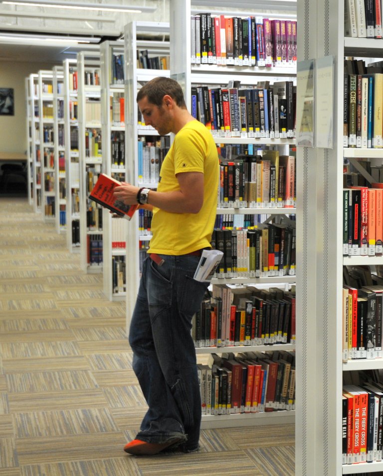 Man browsing library shelves