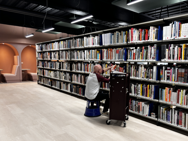 library shelving with staff shelving books