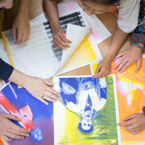 students looking at three colour images