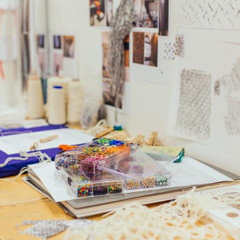 desk space with pins and other textile materials