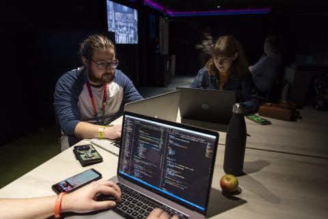Three people working with laptops
